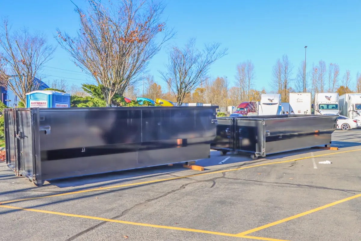 Professional dumpster rental service with roll-off container on residential driveway in Wanaque